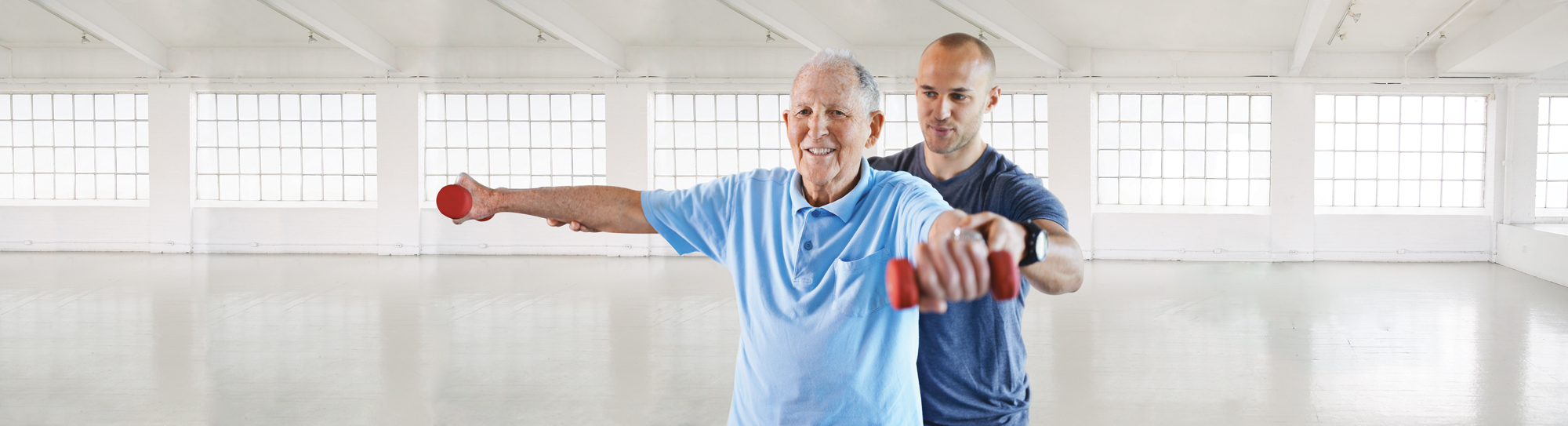 man helping senior work out