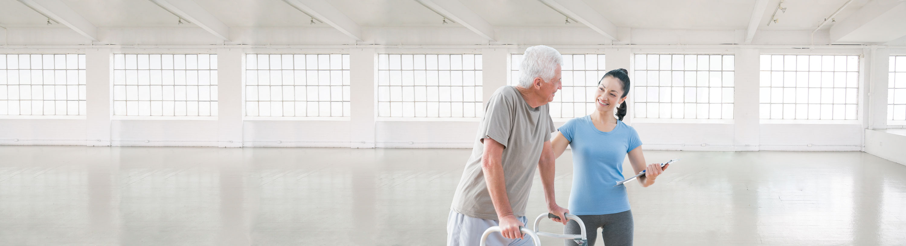 woman helping senior man walk